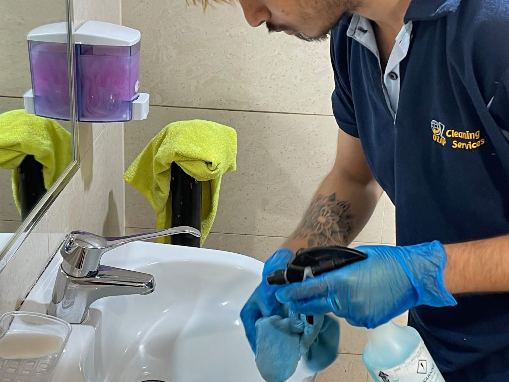 Team member is cleaning sink